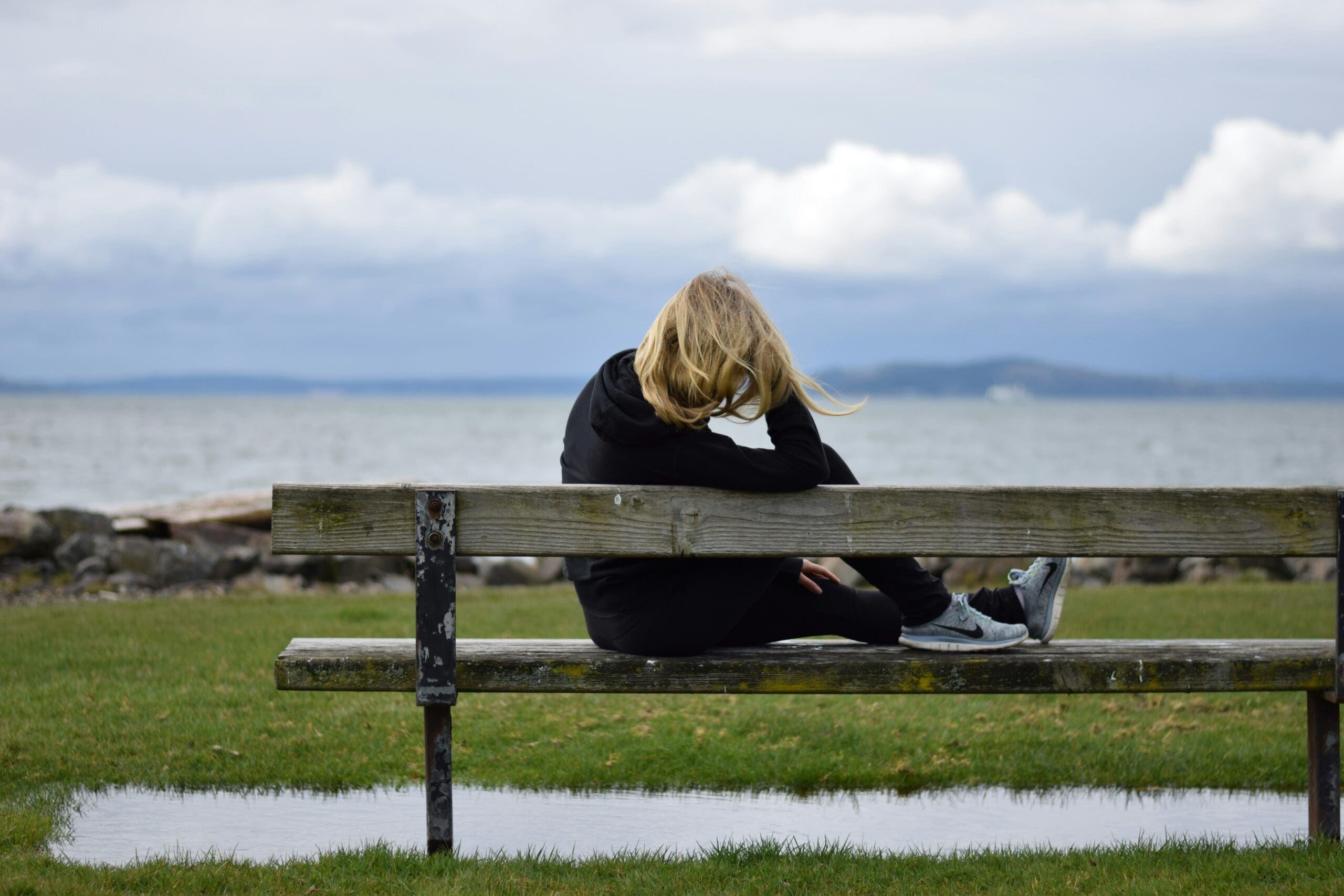 woman waiting on bench