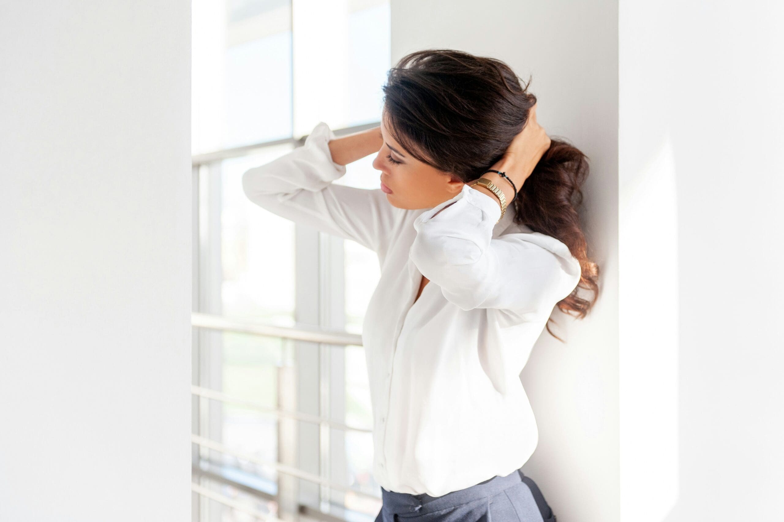 tired woman pulling hair back